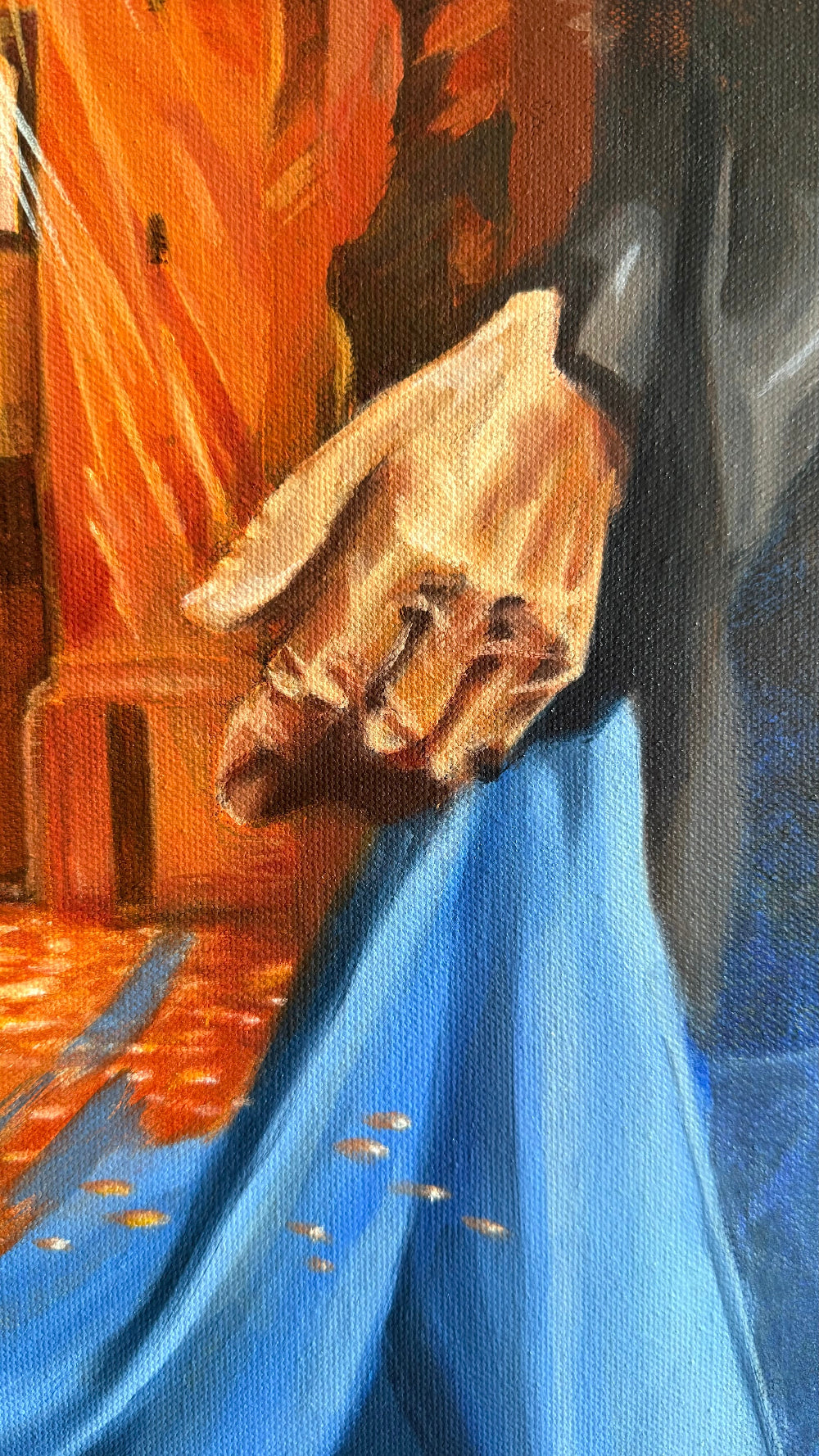 Detail of The Light We Carry showing the woman’s hand, blue drapery and warm light emerging from the architectural ruin within her figure.