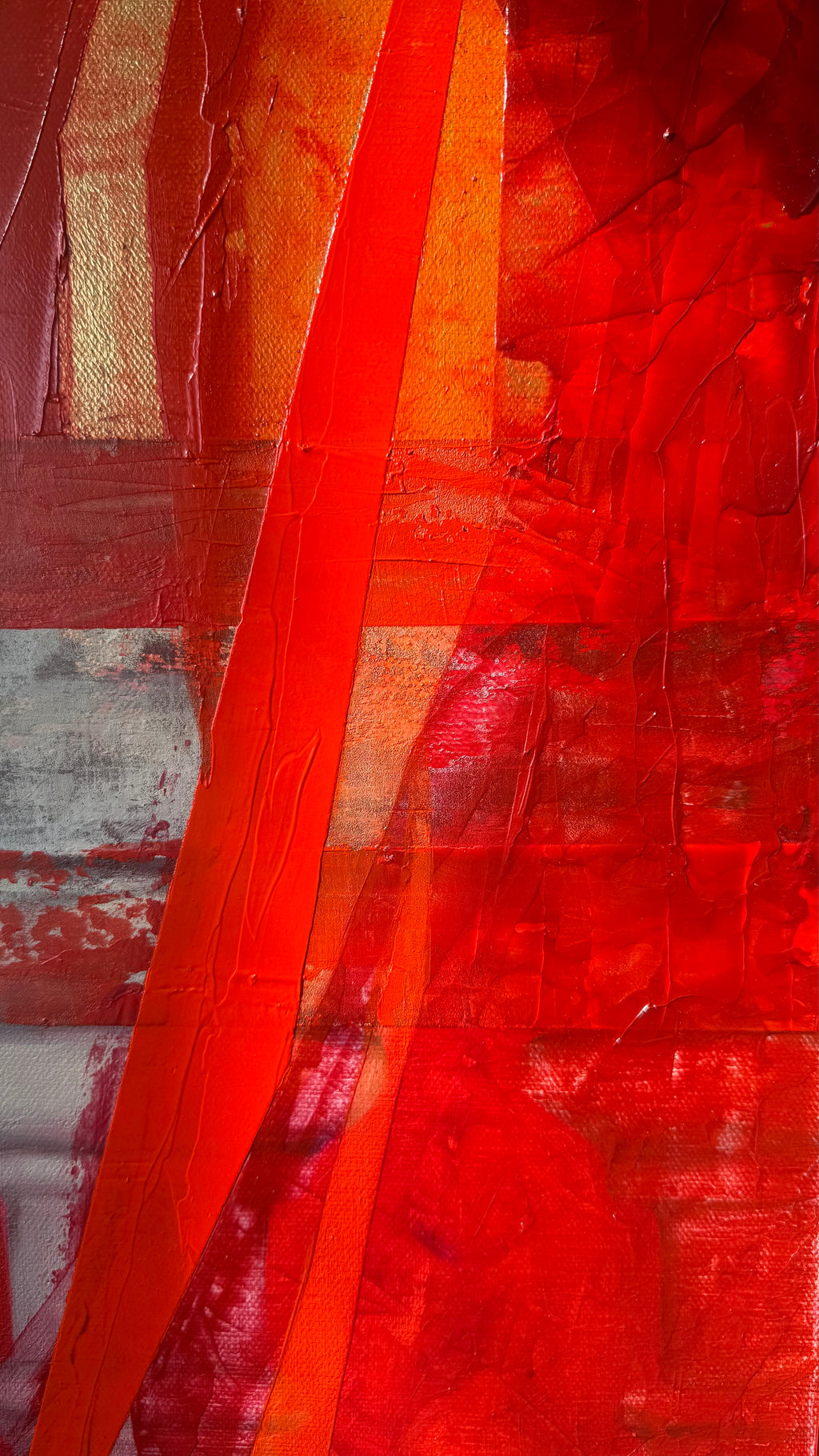 Close-up of bold red vertical forms with layered texture and expressive brushwork contrasting with gold background