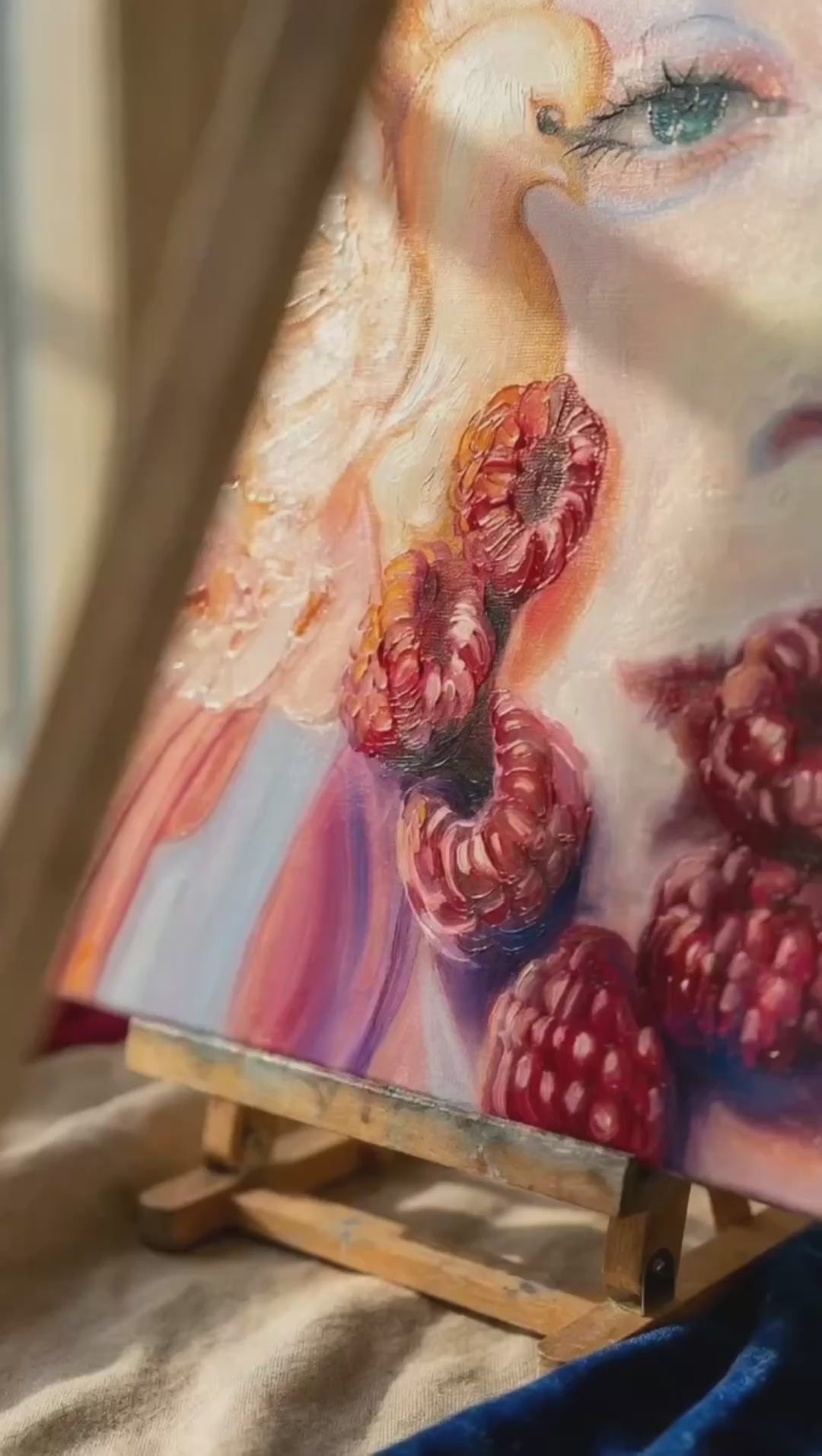 Raspberry Peace oil painting on an easel with a bowl of raspberries on the table in a warm kitchen setting